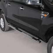 A pair of black metal truck side steps mounted on the side of a glossy black pickup truck, shown against a neutral gray studio background.